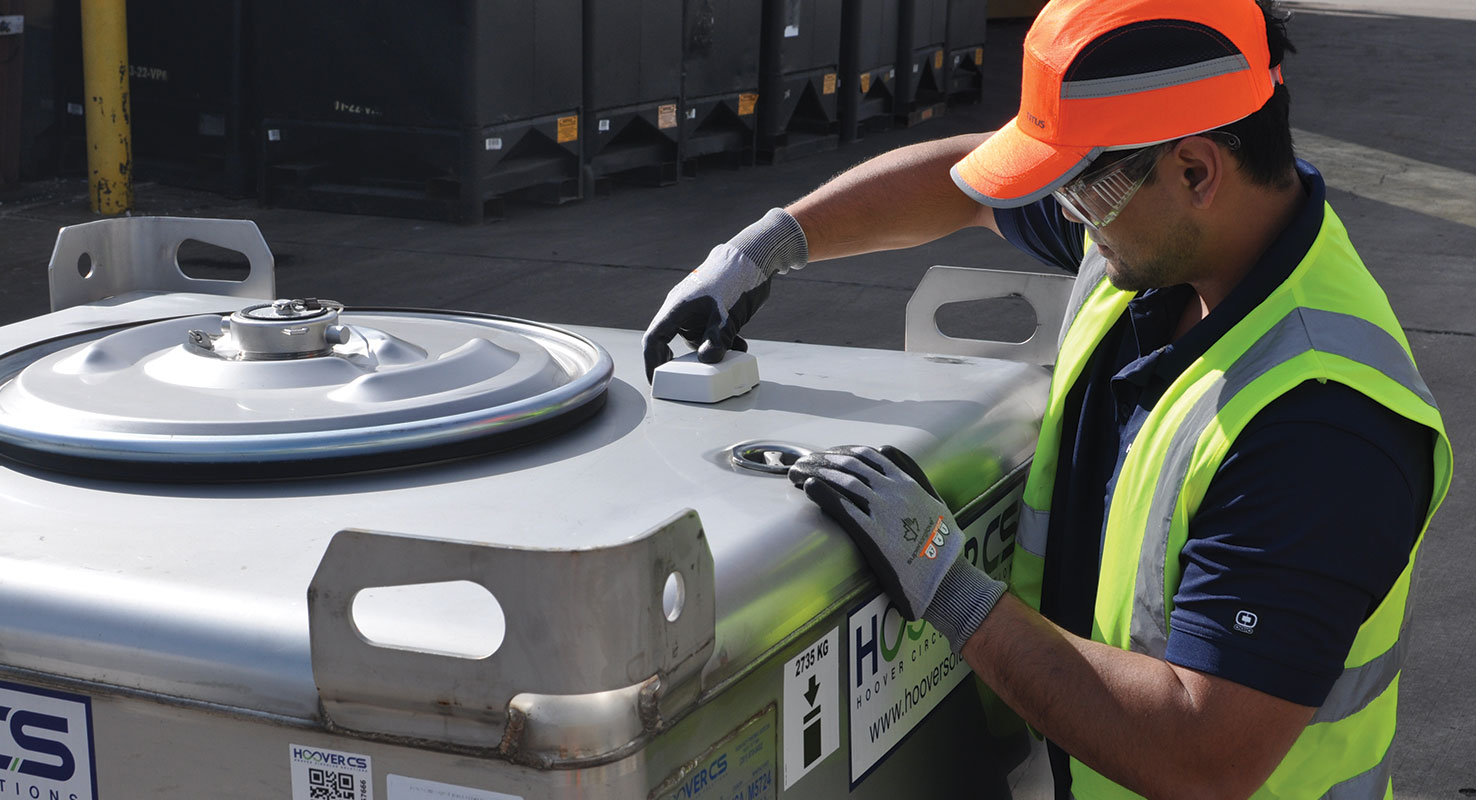 Hoover CS Tech installing an Advanced IBC Container Tracking Technology on a stainless steel Intermediate Bulk Container